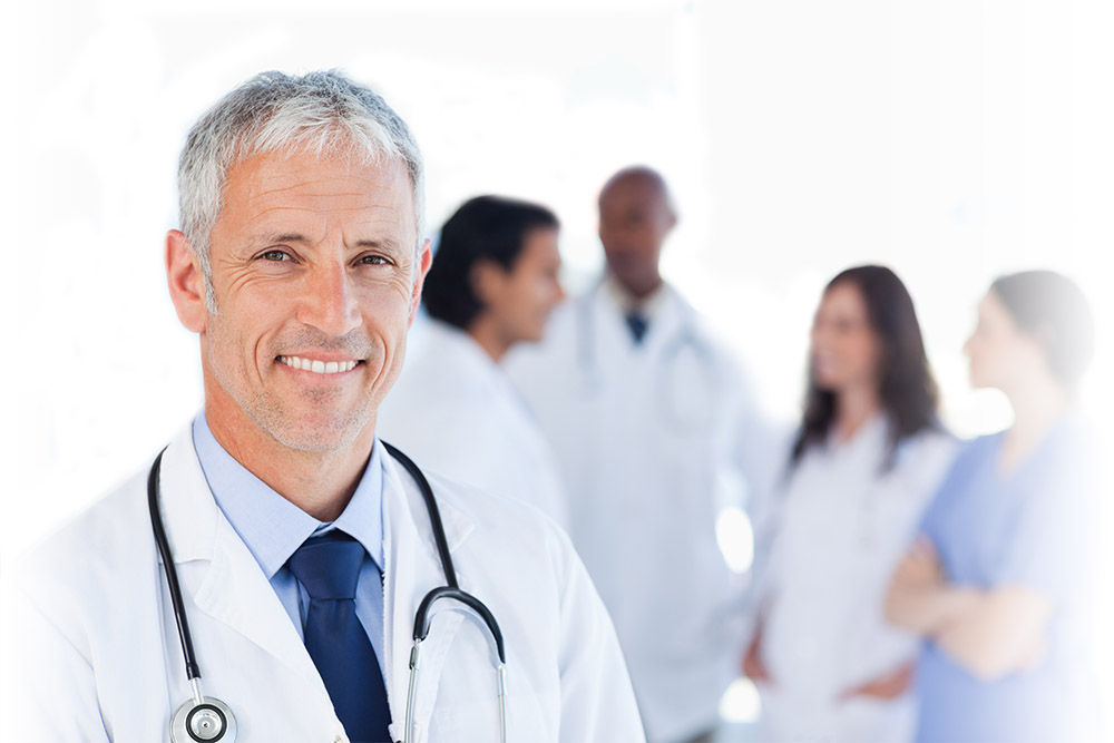 Smiling doctor waiting for his team while standing upright